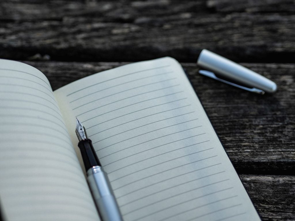 A blank notebook with fountain pen