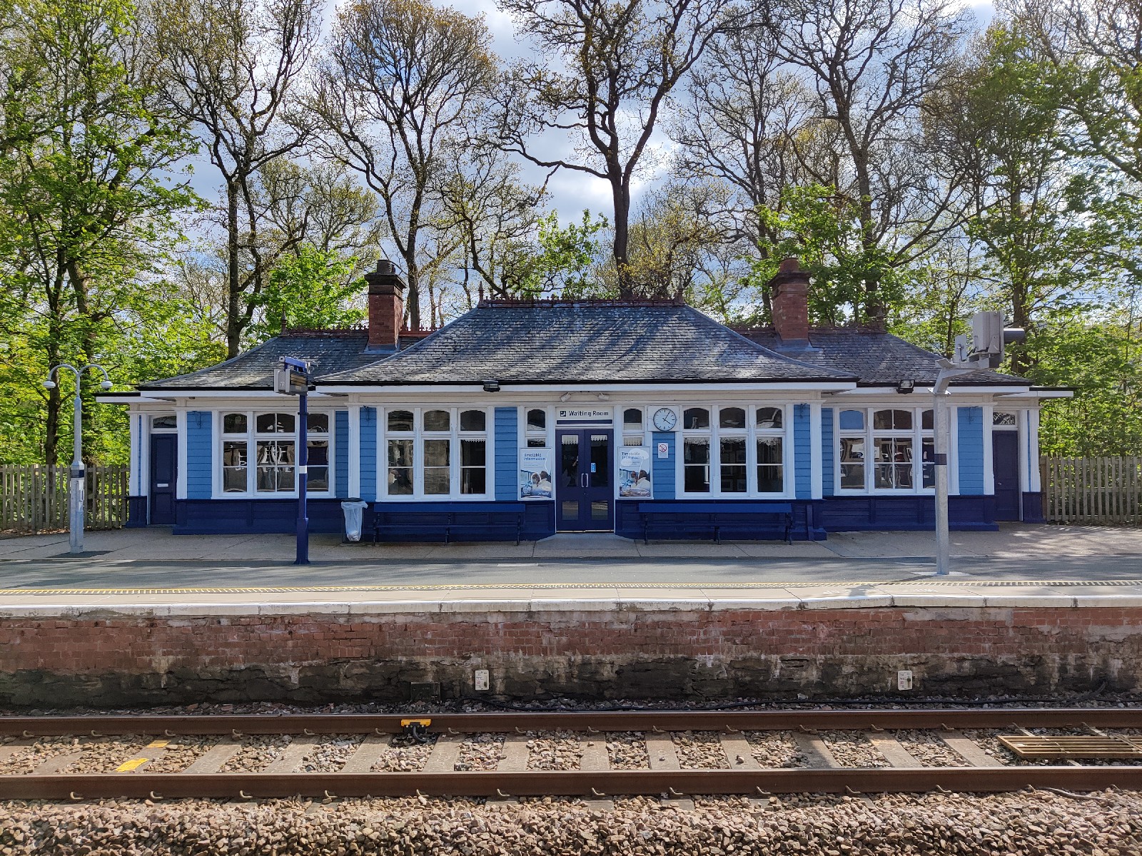 A cute blue painted waiting room on the platform at the railway station