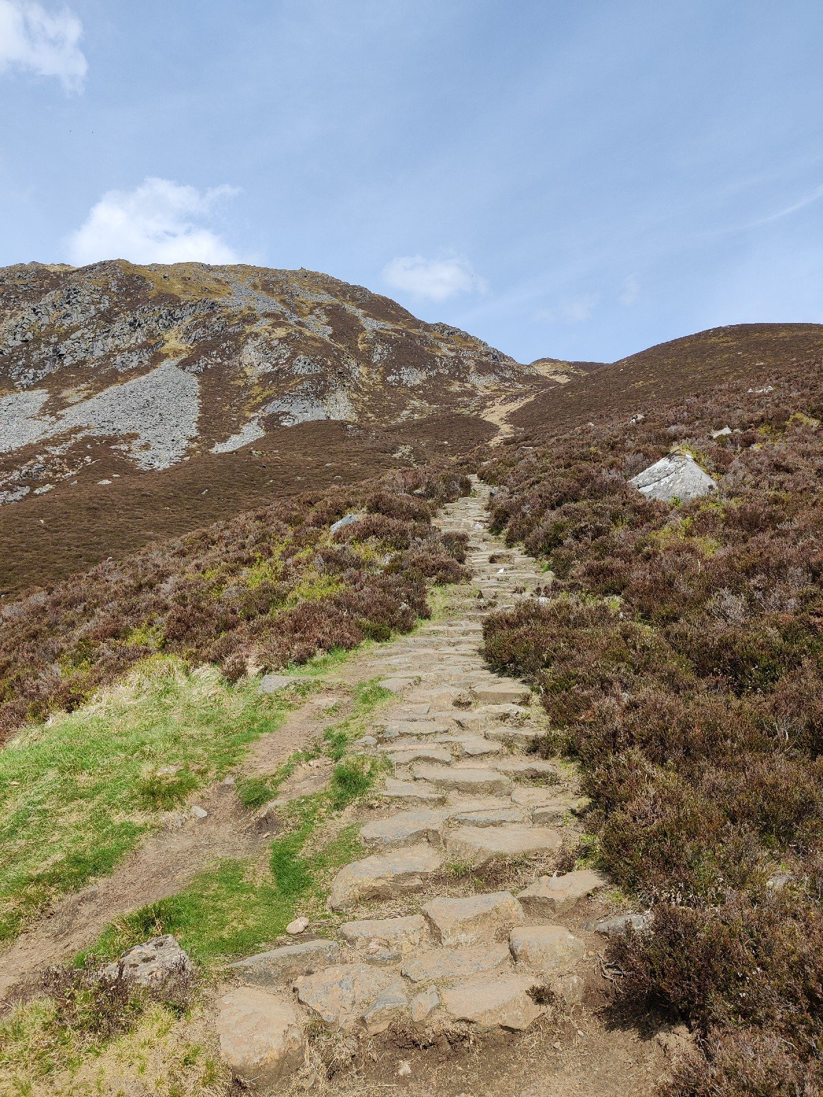 Steep rock steps climbing all the way up the mountain from the base of the summit.